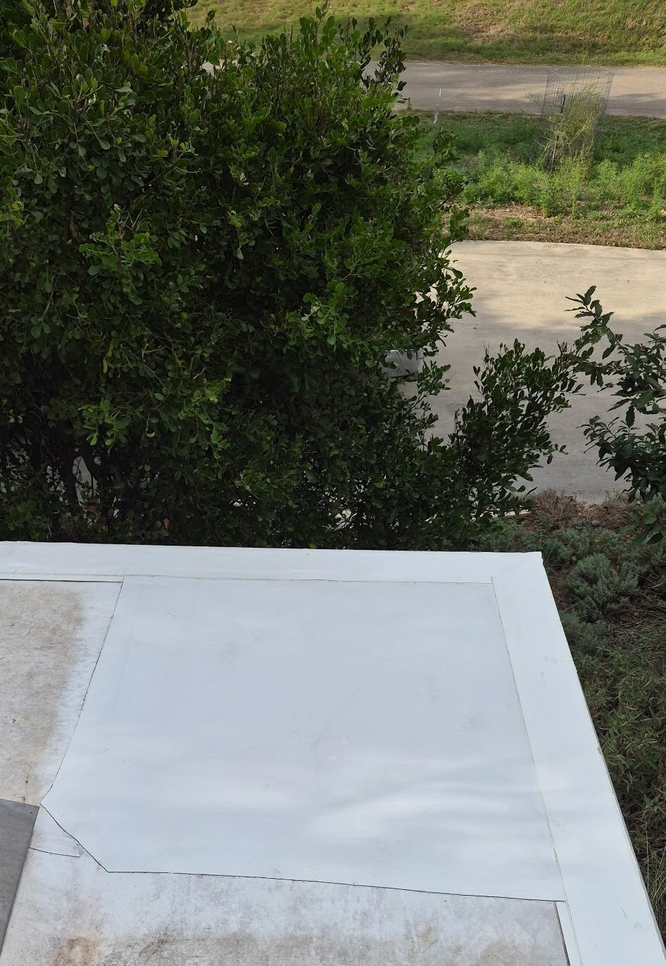New white TPO membrane installed over the repaired corner section of the roof